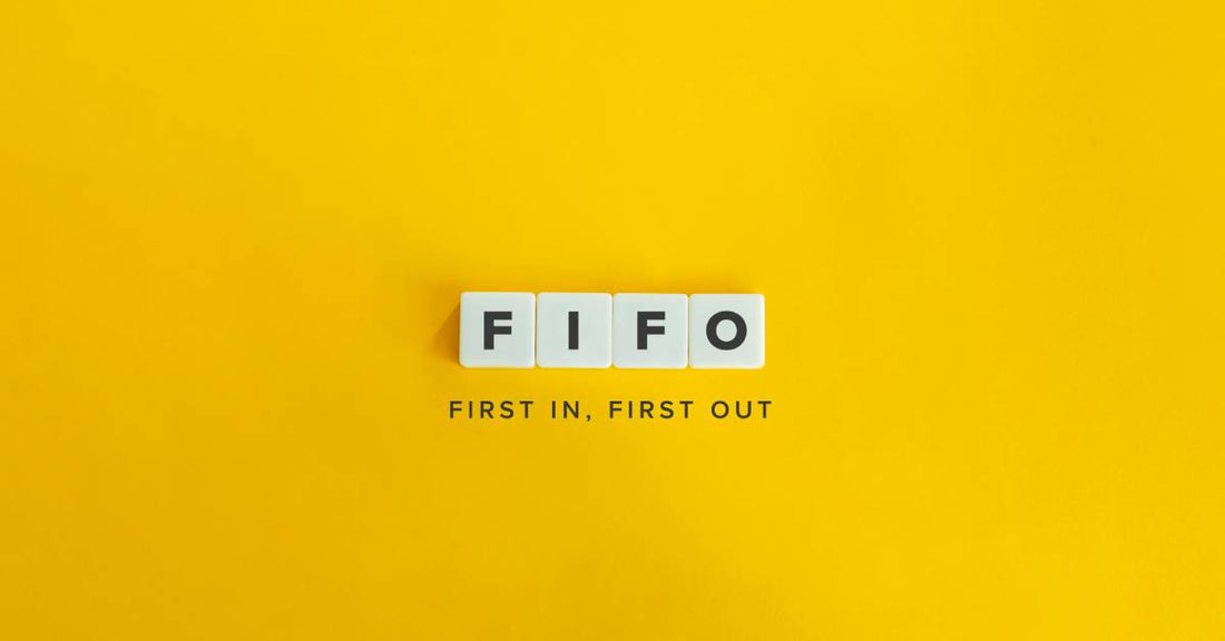 A minimalist image of a yellow surface in which the words "First In, First Out" sit under tiles that spell "FIFO."