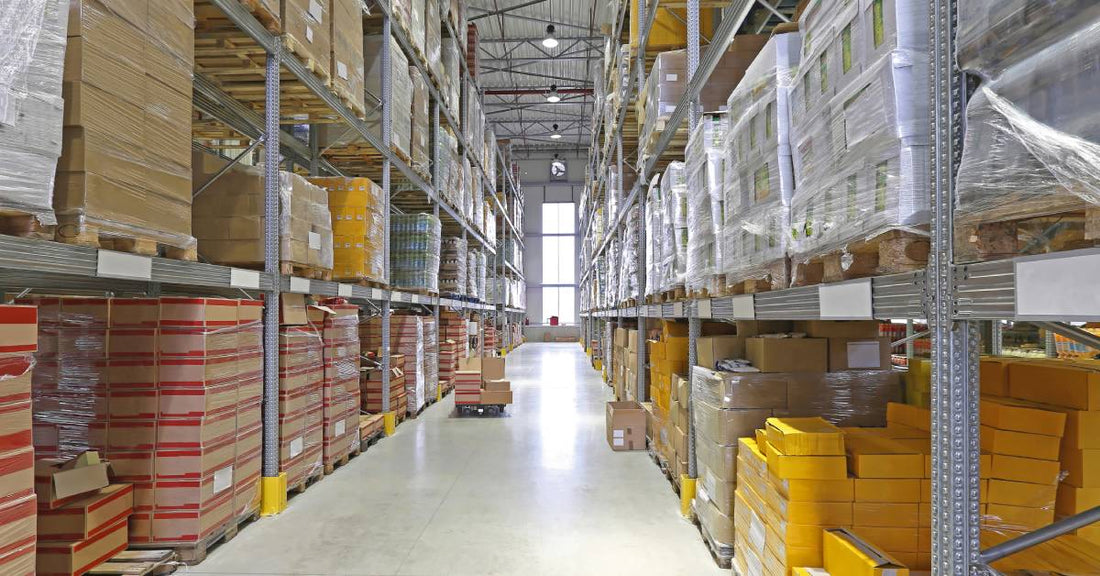 The view of a warehouse fulfillment center filled with boxes and products stacked on pallet racks.