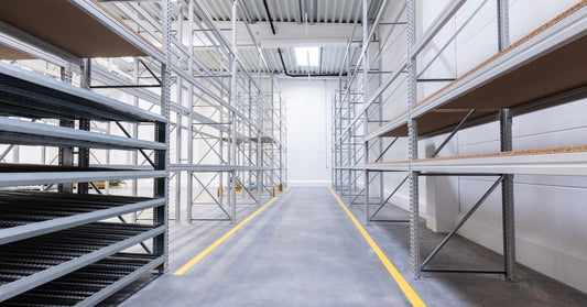 A small part of a warehouse with industrial shelves set up. There are no items on the different levels of the shelves.