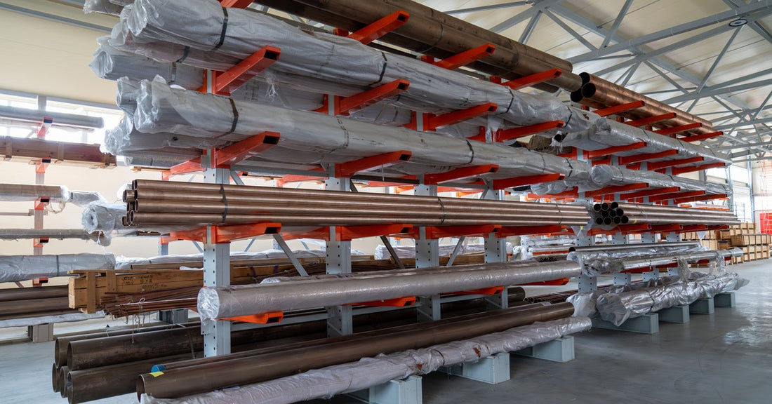A set of warehouse cantilever racking shelves holding copper pipes of various sizes. They are in outdoor storage.