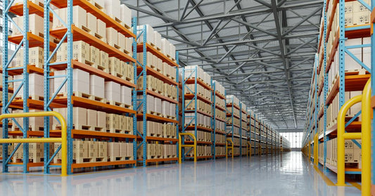 A modern warehouse interior with clean, while floors. The space is filled with tall pallet racking shelves.