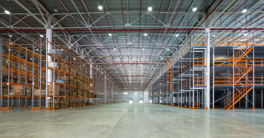 A large, well-organized warehouse with a combination of racking systems and shelving systems installed.