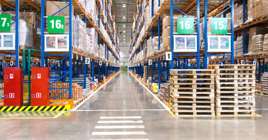 A crosswalk leading to an aisle between storage racks in a warehouse, with the racks labeled by numbers.