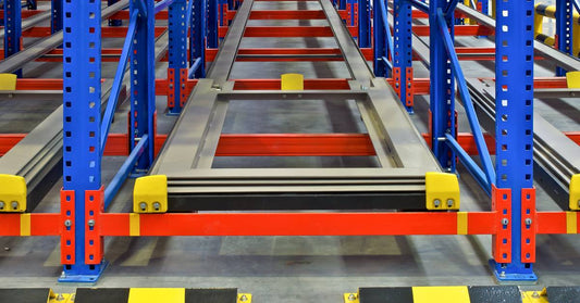 The base of an empty pallet shelving system with an unobstructed view from the front to the back of the shelves.