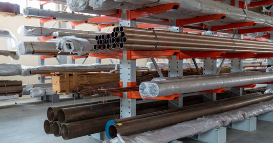 Rows of cantilevered racks. They all hold copper pipes. Some pipes are wrapped in plastic, others aren't.